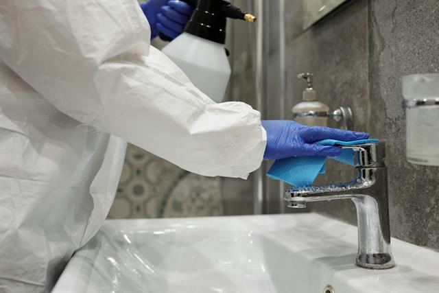 pexels-matilda-wormwood-4098837 a-person-fixing-sink